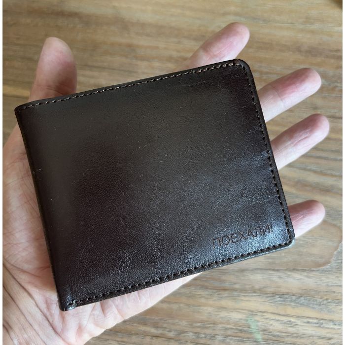 Yuri Gagarin Soviet vintage leather wallet shown handheld with Poyekhali engraving
